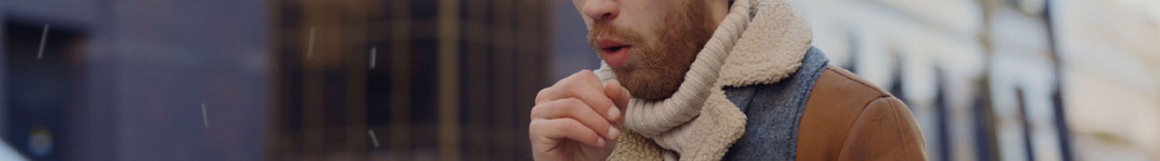 Person holding an inhaler close to the mouth